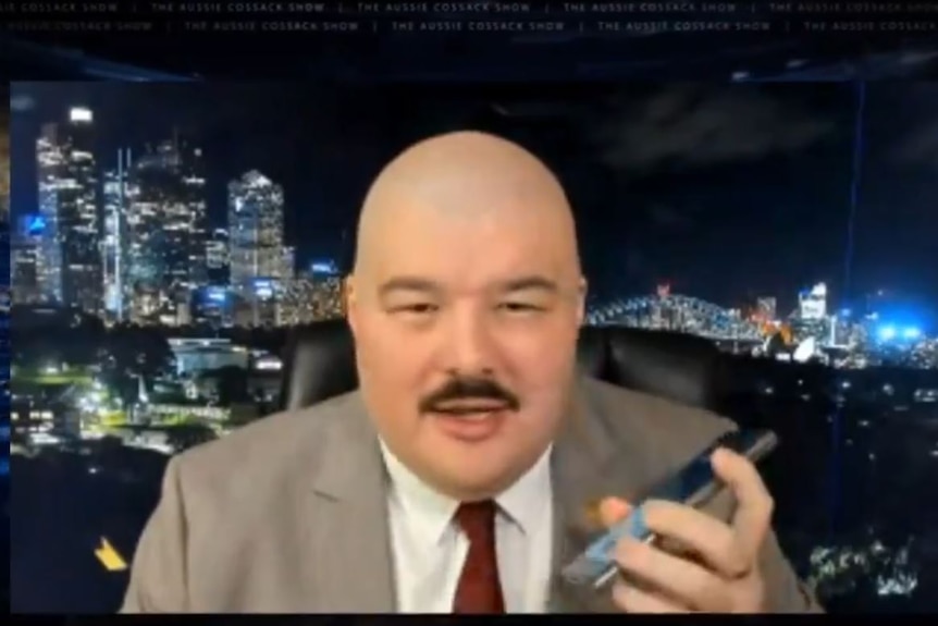 A screen grab from a video showing a man speaking on a mobile phone.