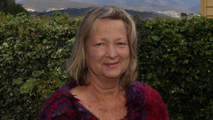 Sue McCuaig standing in front of a hedge with Mt Wellington in the background, Hobart, Tasmania April 2020