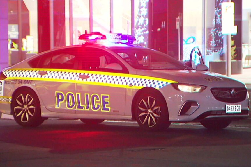 A police car with its flashing lights on.