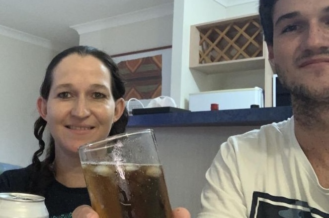 Selfie of woman and young man holding beers.