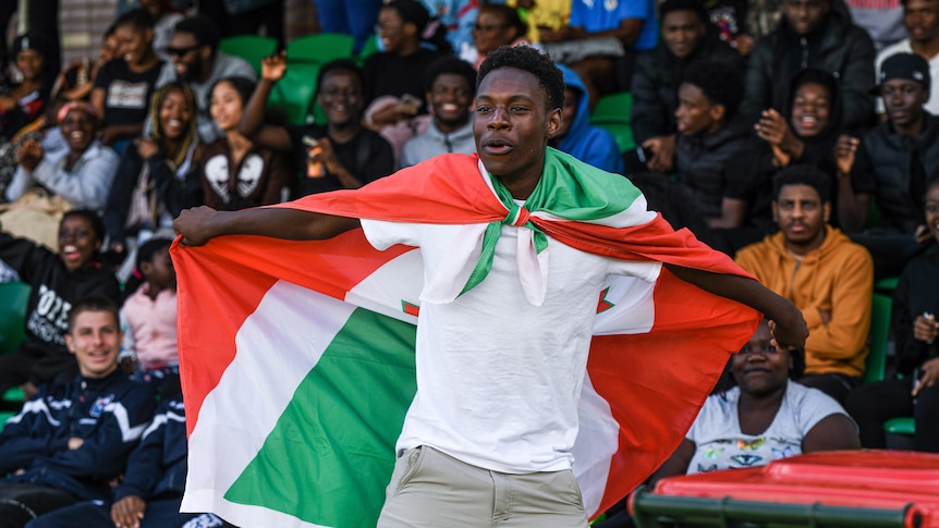 A fan celebrates a goal at the Burundi v Kenya match for Perth African Nations Cup. 