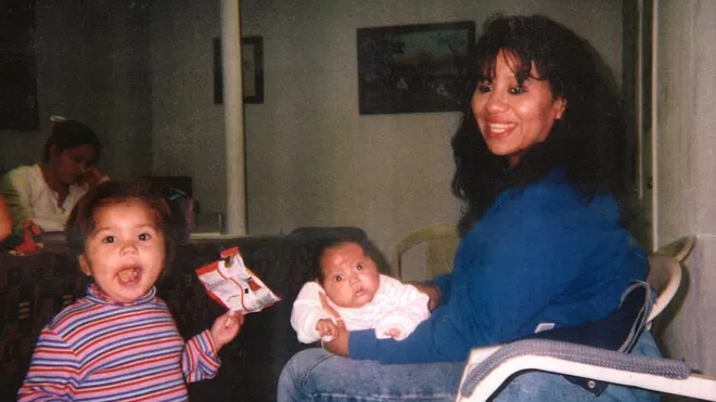 A photograph of Melissa Lucio sitting down with her daughters.