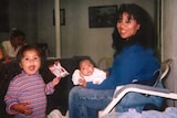 A photograph of Melissa Lucio sitting down with her daughters.