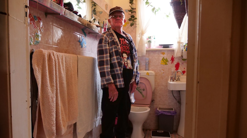 a man stands in a bathroom