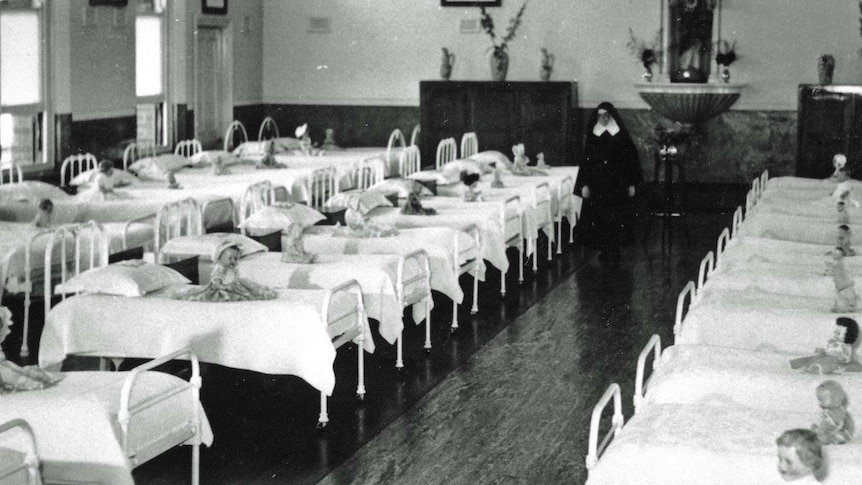 Toy dolls on beds at St Joseph's orphanage.
