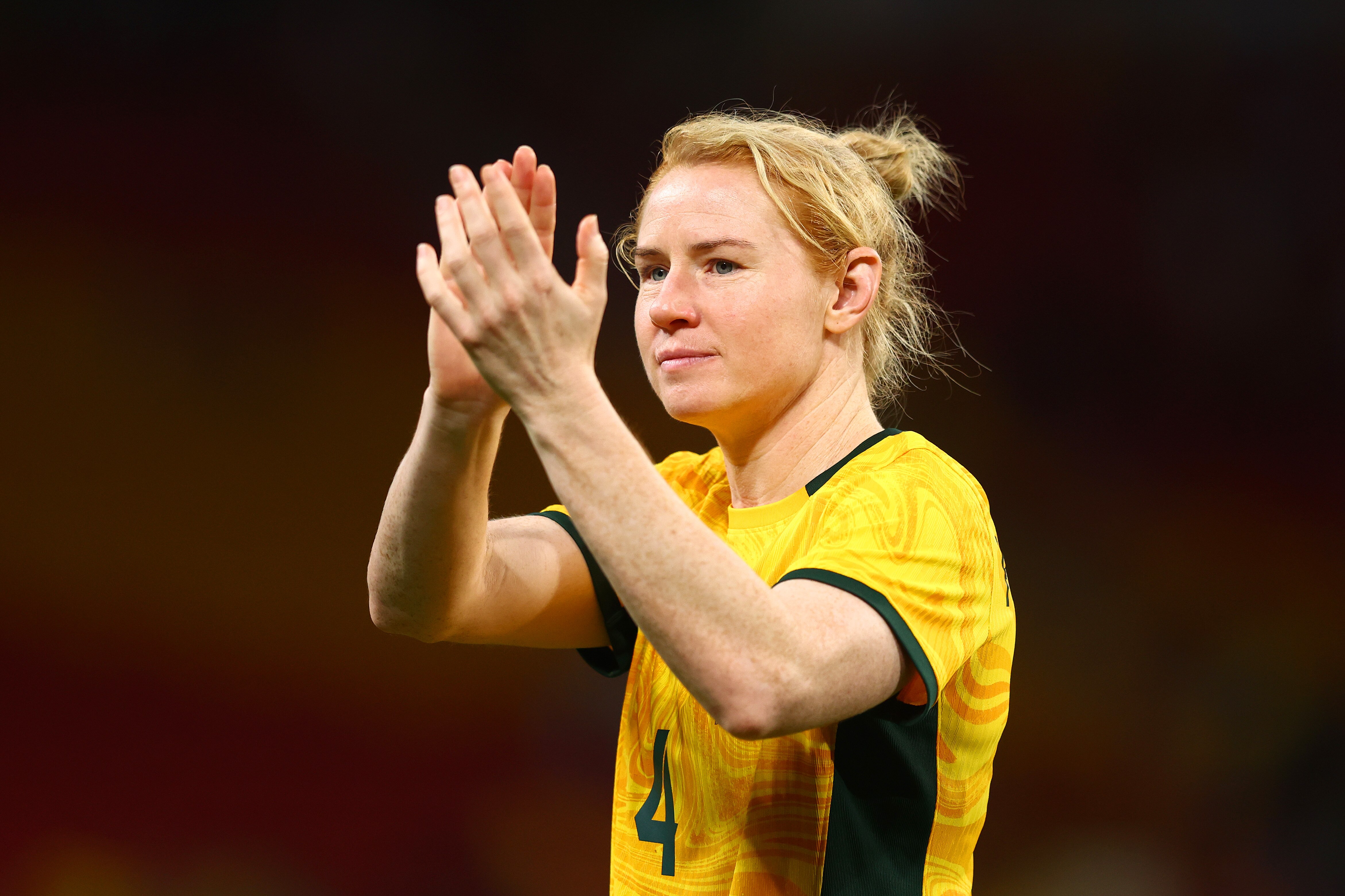 Clare Polkinghorne claps her hands after a Matildas match.