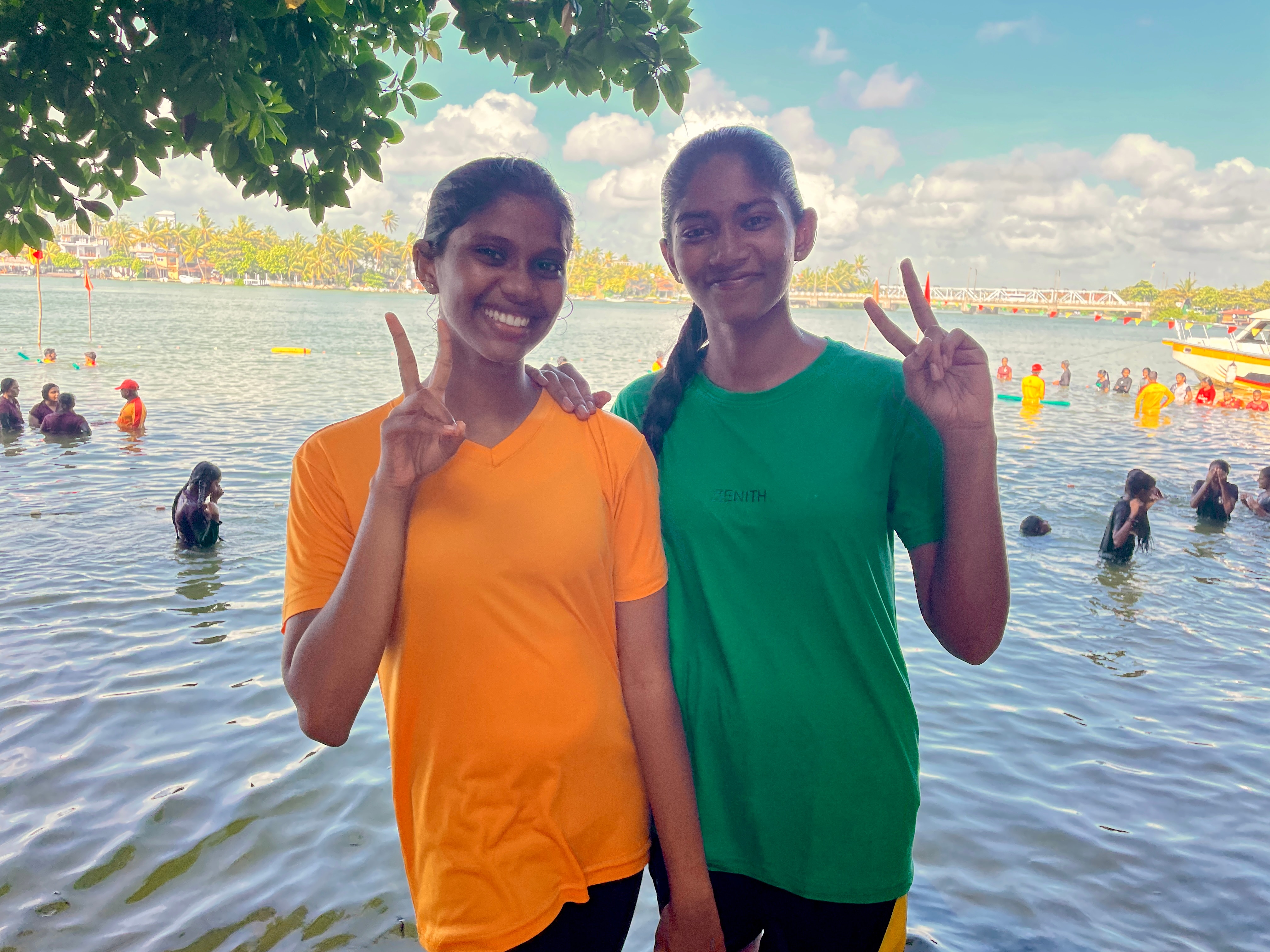 Duas garotas sorriem para a câmera.