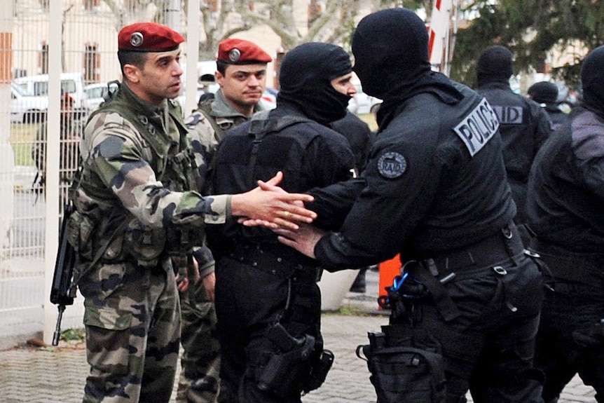 French police shake hands after marathon siege