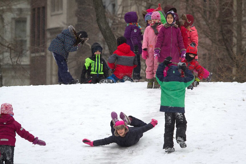 Children play in the snow in Central Park, New York