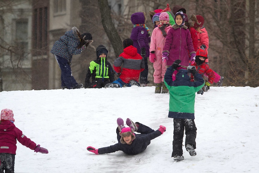 Children play in the snow in Central Park, New York