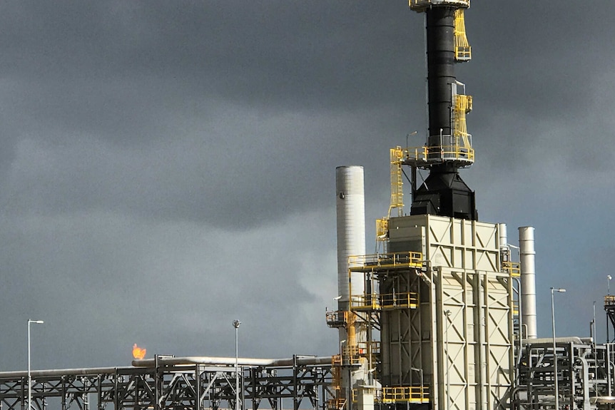 A flame bursts from the top of the metal cages at the Longford gas plant.