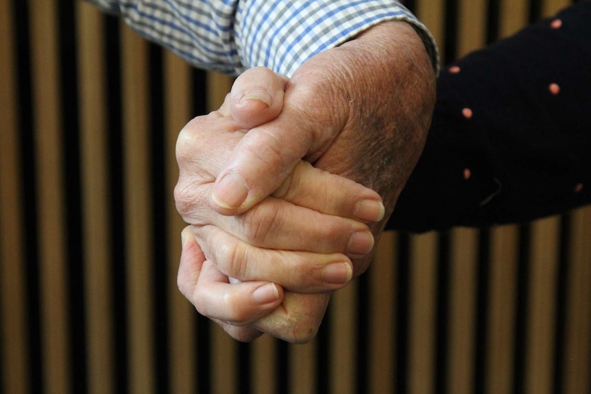 A man and woman holding hands