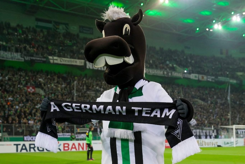 Borussia Monchengladbach's mascot and 'A German Team' scarf