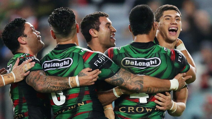 On the board ... Kyle Turner (R) celebrates with team-mates after scoring a try for the Rabbitohs