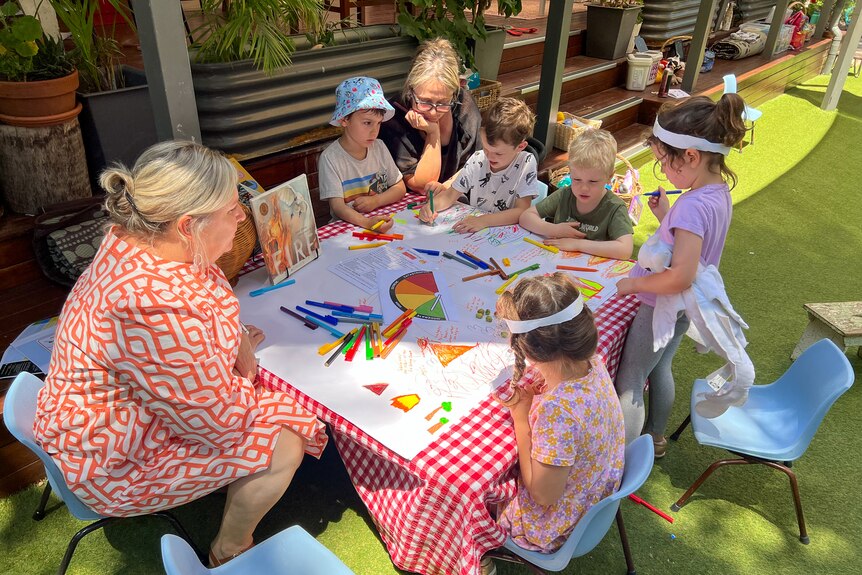 A group of children at a table colouring in at Blaxland Preschool, New South Wales, December 2023.