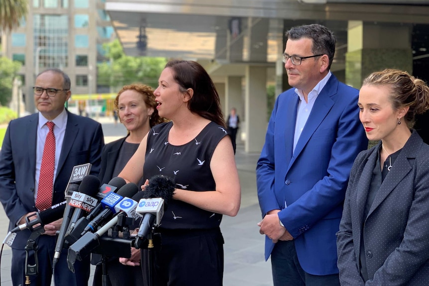 Newly re-elected Victorian Premier Daniel Andrews stands with new cabinet members.