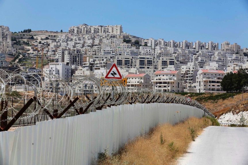 Razor wire covers a section of the controversial Israeli barrier