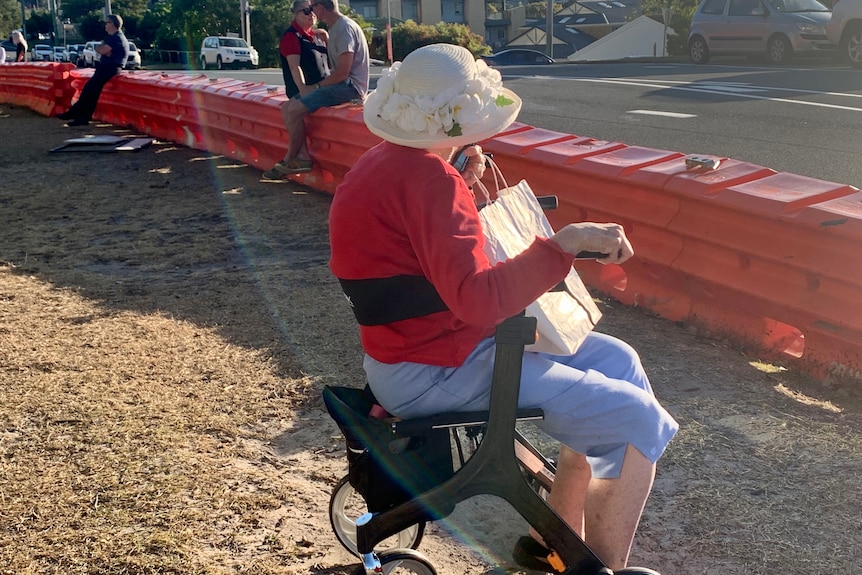 woman sitting in walker at the border