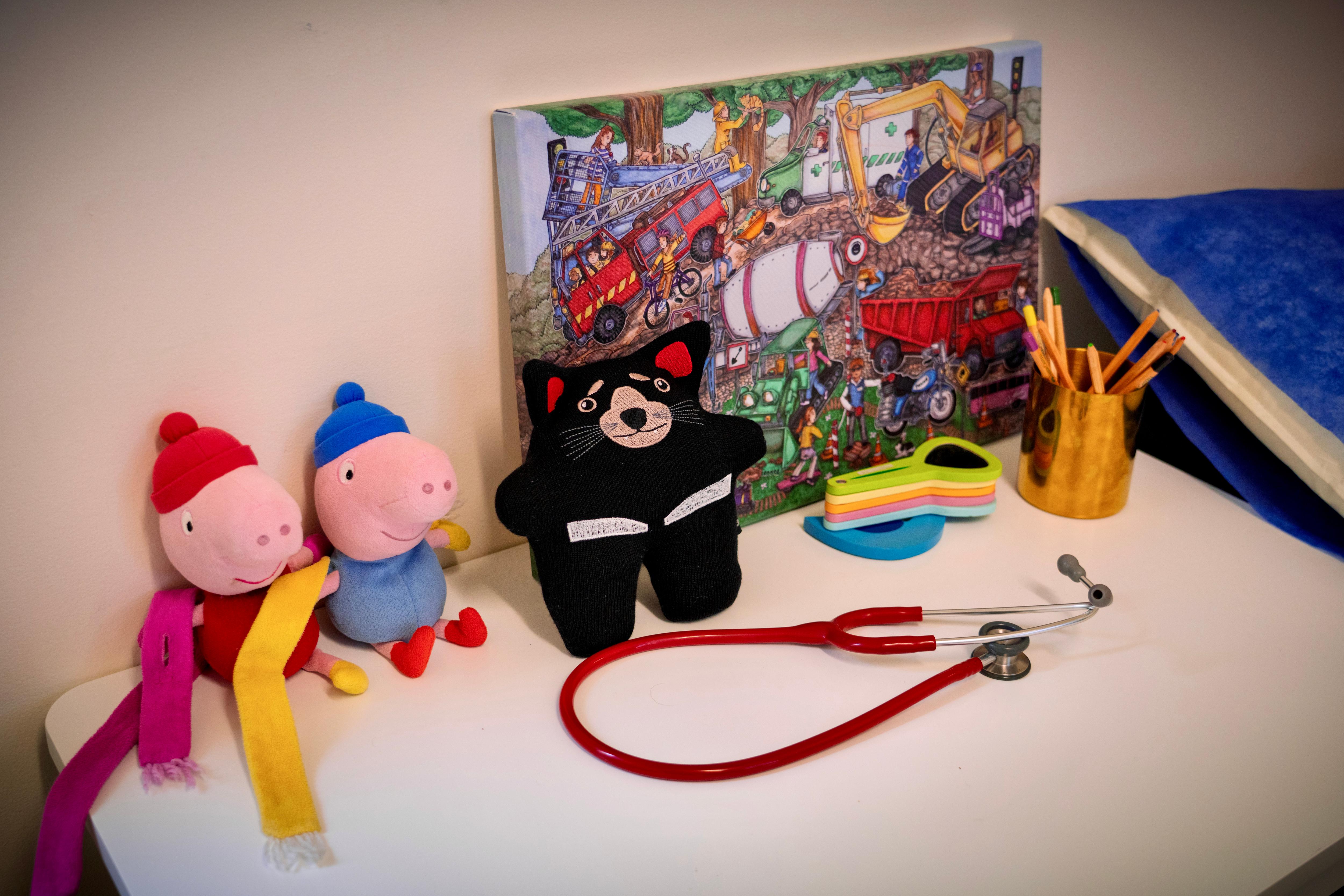 Teddy bears and a stethoscope lying on a white tabletop