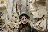 A dummy dressed in army fatigues and a mask showing Bashar al-Assad stands in Aleppo.