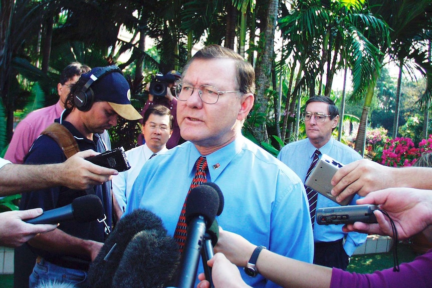 Denis Burke surrounded media.