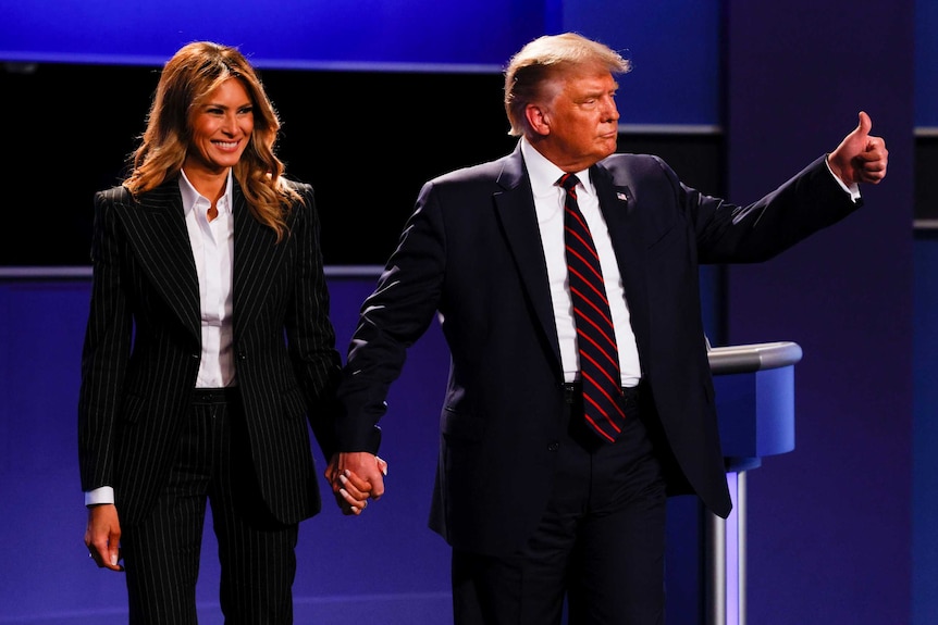 Donald Trump giving a thumbs up while his wife Melania smiles