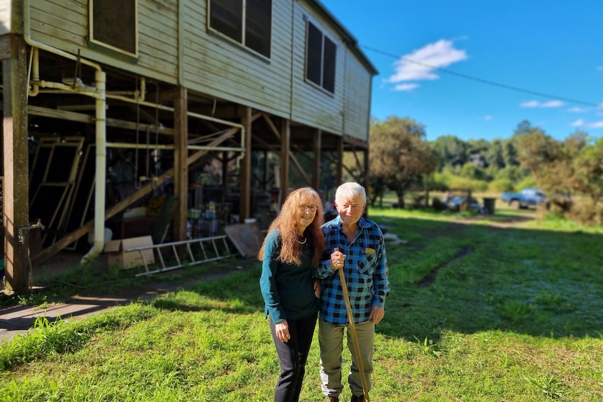 Lismore MP Janelle Saffin and her husband Dr Jim Gallagher standing in front of their two story home.