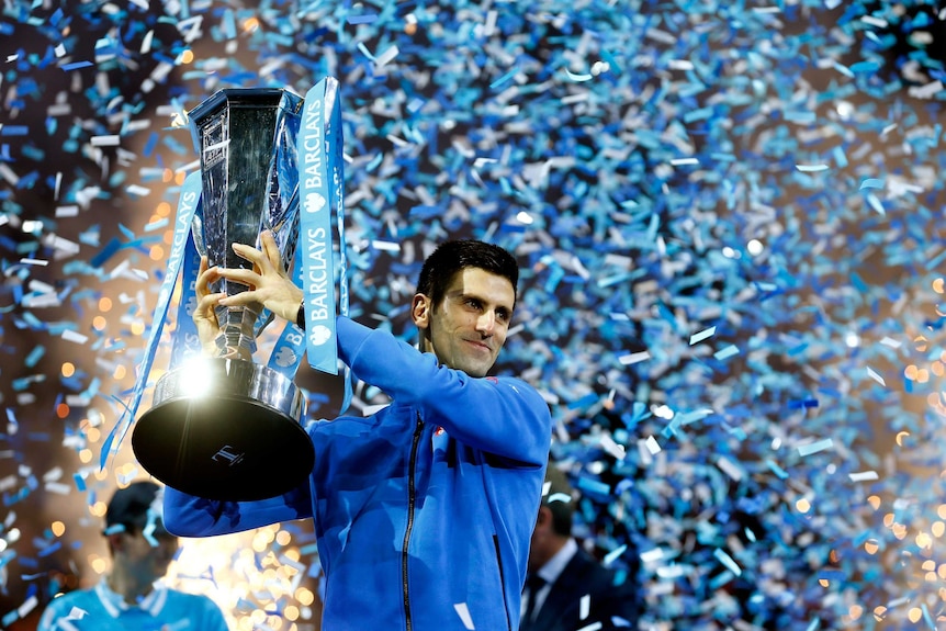 Novak Djokovic of Serbia lifts the trophy following his victory during the men's singles final
