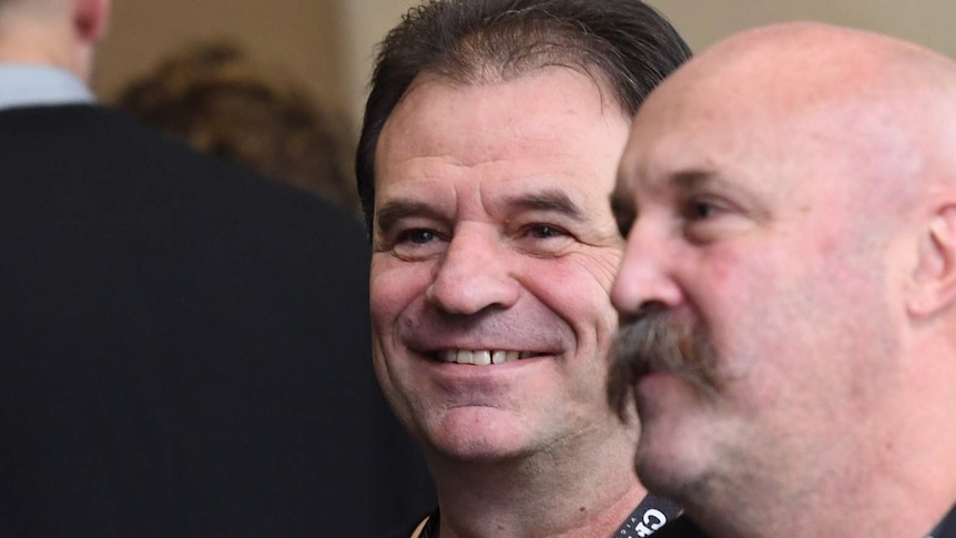 A smiling John Setka wears a CFMEU shirt. He stands next to Shaun Reardon.