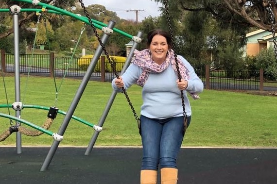 A woman swings on a swing