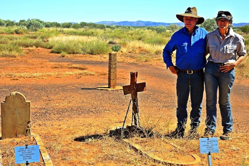 A photo of Trevor and Suzie Tough standing next to several graves at Myroodah Station