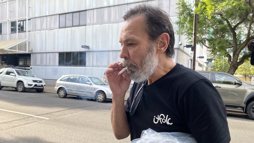 Aleh Sidorchyk smokes a cigarette as he walks out of the Adelaide city police watch house.