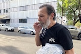 Aleh Sidorchyk smokes a cigarette as he walks out of the Adelaide city police watch house.