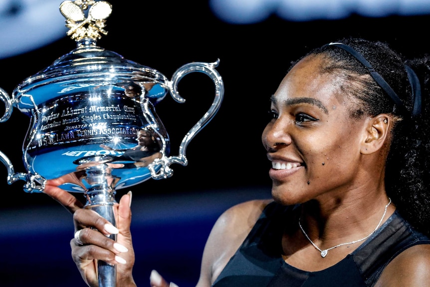 Serena Williams poses with the Australian Open trophy after her victory on Saturday evening.