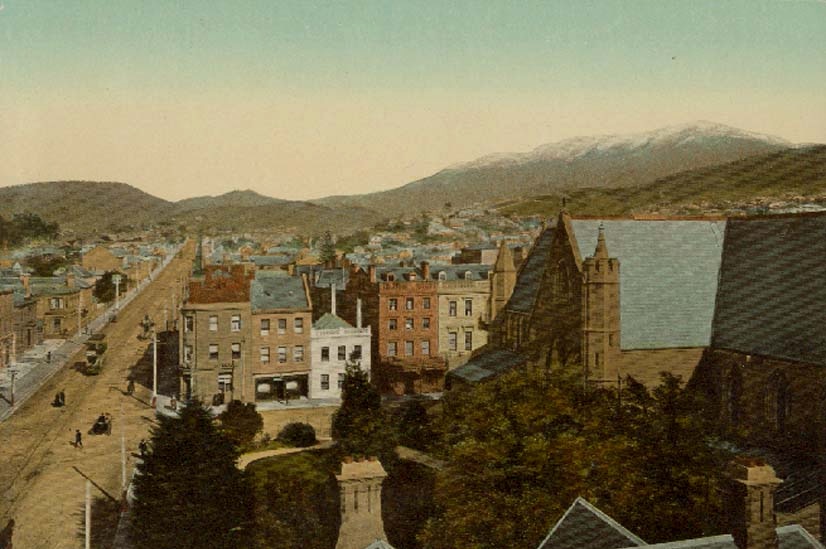 Old and coloured photograph of Macquarie Street in Hobart with colonial buildings looking up at a snowy Mt Wellington