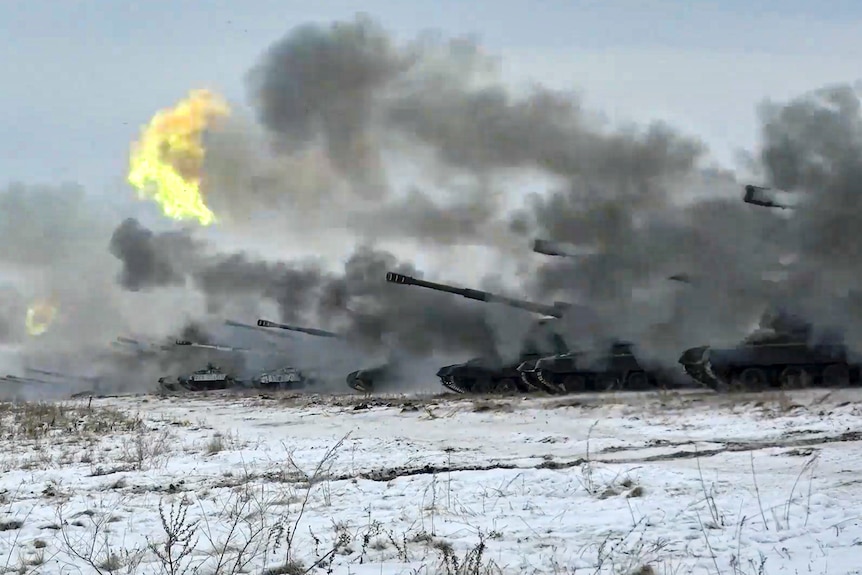 Heavy artillery weapons being fired in a wintry landscape
