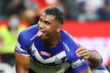 An NRL player celebrates after scoring a try