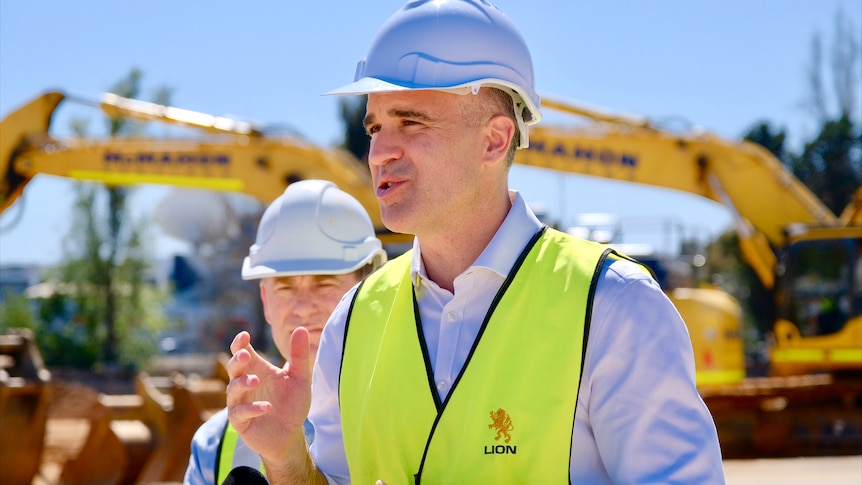 The premier of south australia in hard helmet and vest speaking 