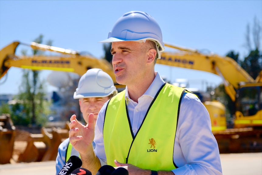 The premier of south australia in hard helmet and vest speaking 
