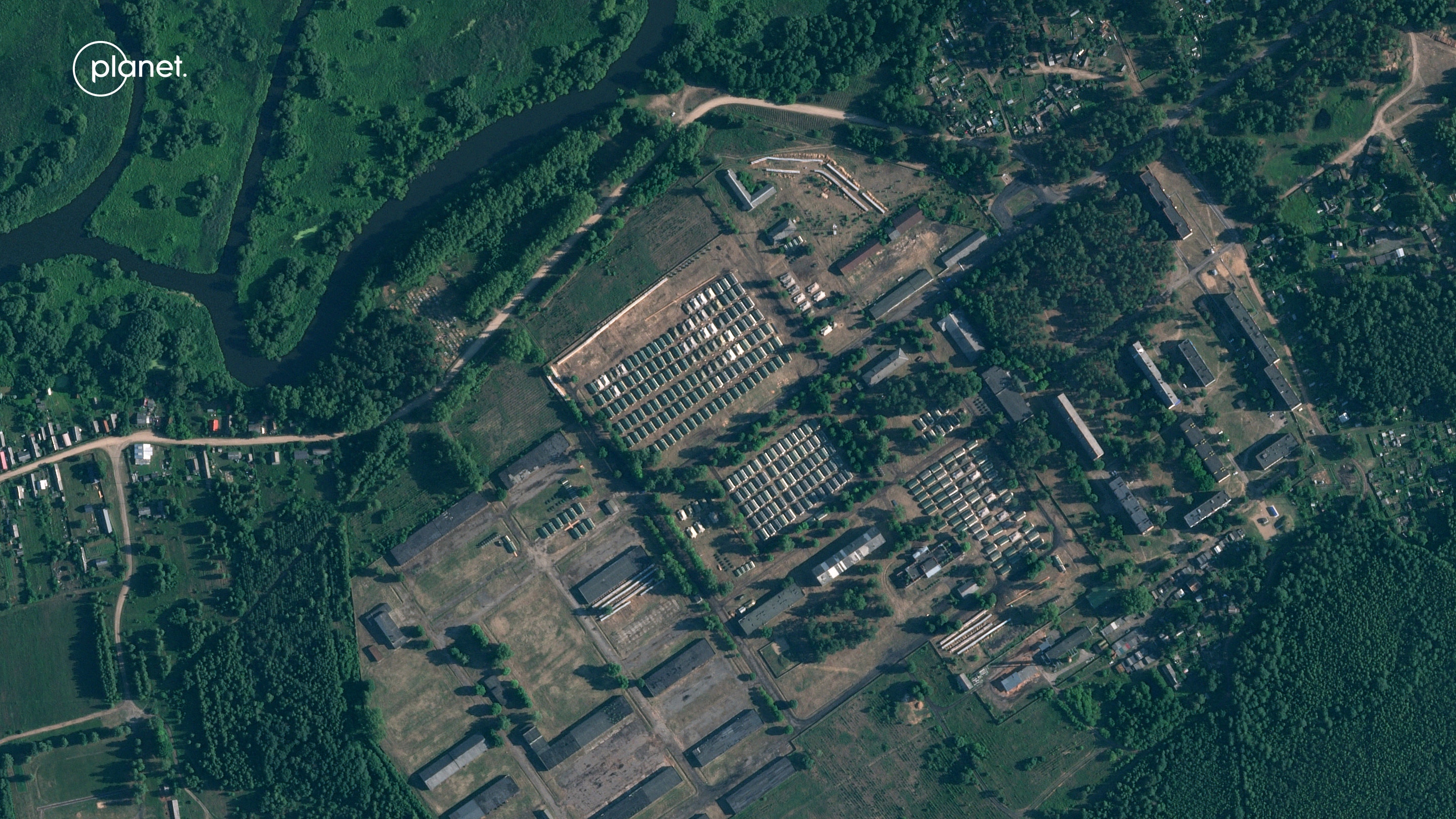 A satellite view of buildings surrounded by green trees.