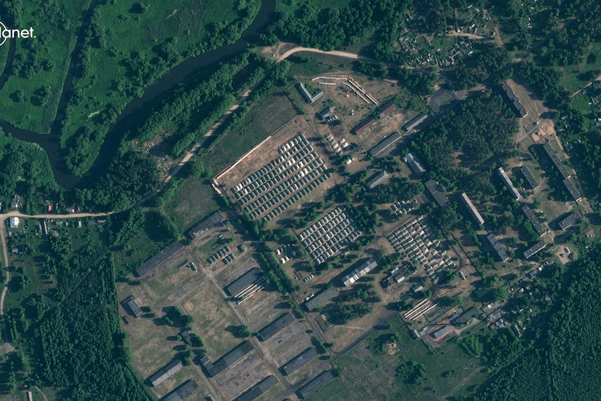 A satellite view of buildings surrounded by green trees.