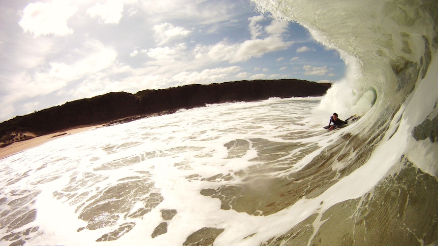 A bodyboarder rides a wave at Cape Paterson, Victoria.