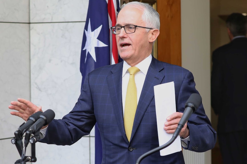 Malcolm Turnbull gestures with both hands as he speaks to the press.