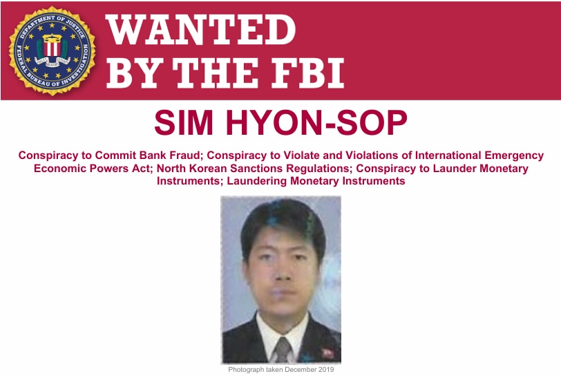 A "Wanted by the FBI" poster of a North Korean male with short black hair.