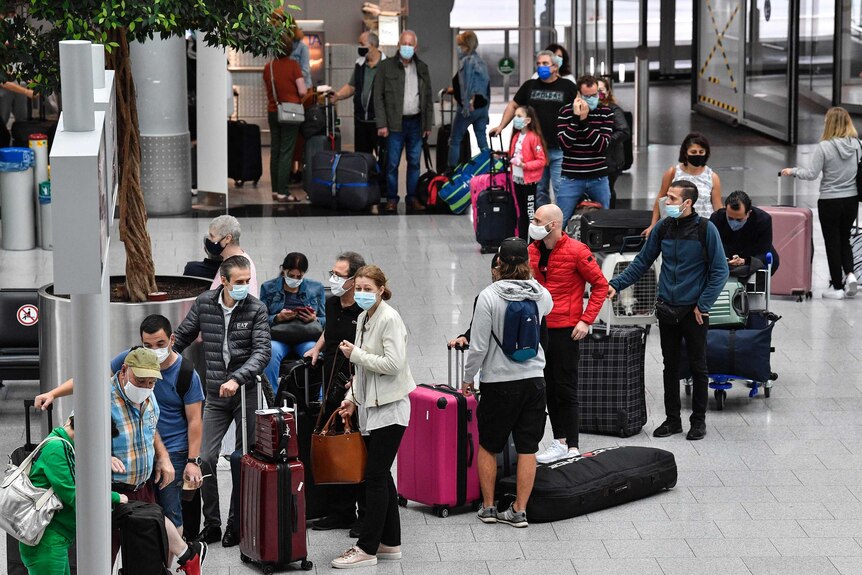 Travellers check in for flights at the airport in Duesseldorf, Germany