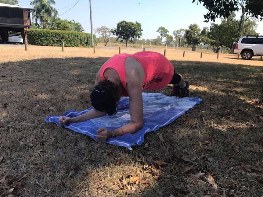 An exercise workshop participant does the plank in a Biloela park