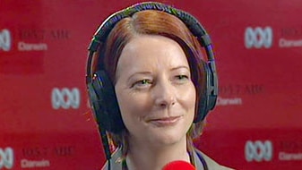 Julia Gillard listens to questions during an ABC radio interview in Darwin