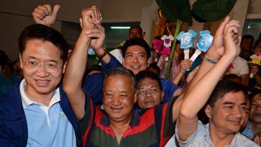 Re-elected governor of Bangkok, Sukhumbhand Paribatra, raises his arms
