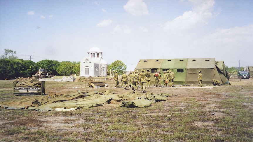 Old photo of tent city with military around it.