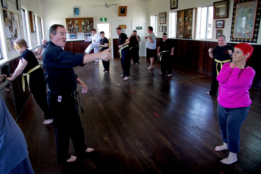 Taekwondo teacher Ian Fauth points towards one of his students.